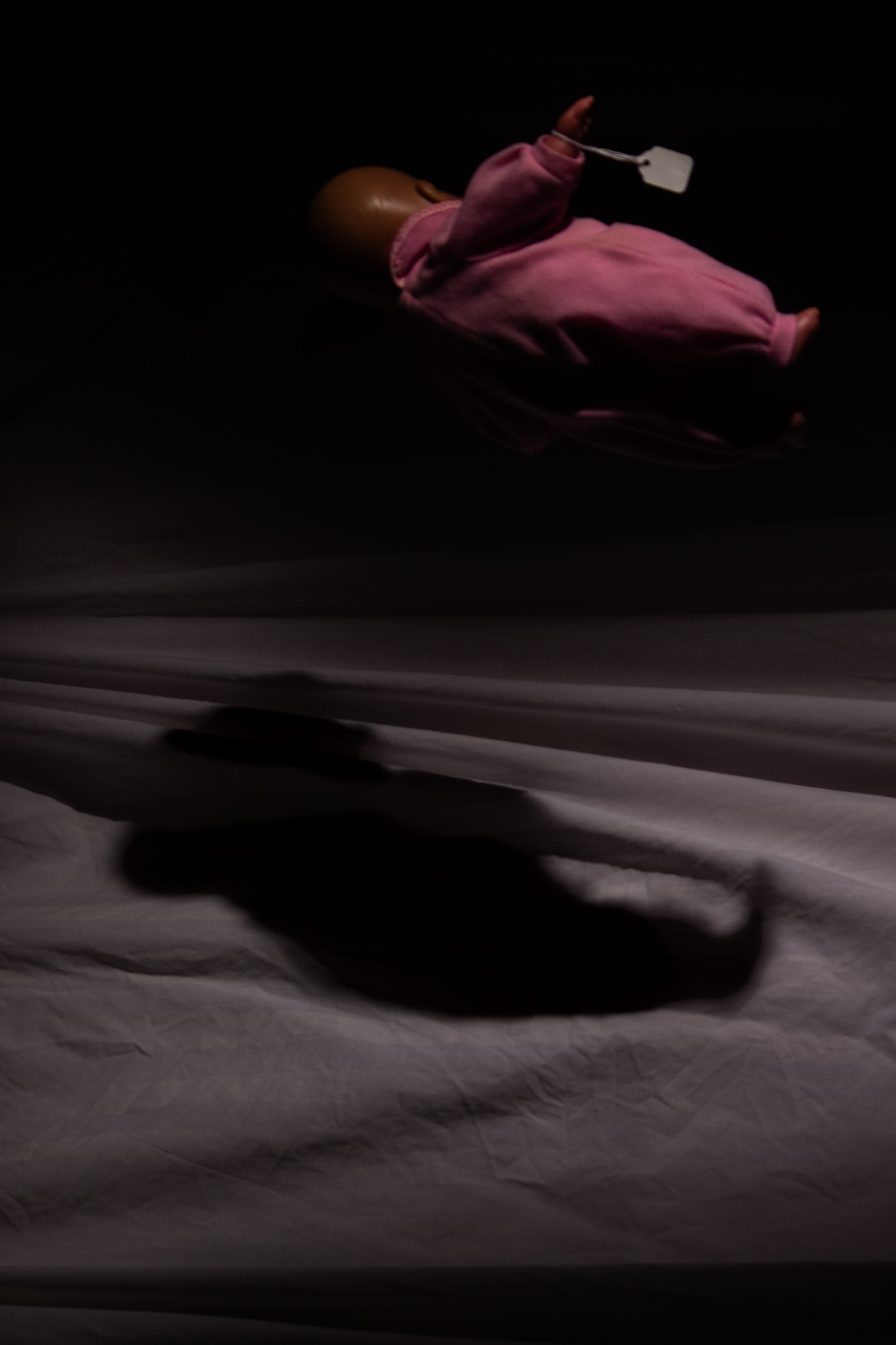 Suspended scary doll