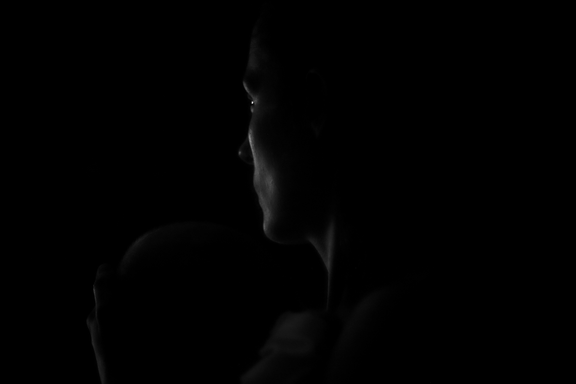 Profile portrait in darkness
